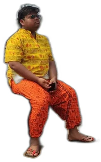 Aditya sitting cross-legged in a saffron outfit
